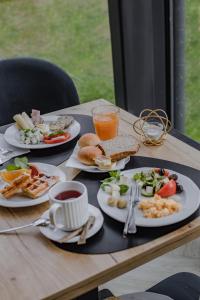 a table with plates of food and drinks on it at Prawdzic Family Resort & Wellness in Gdańsk