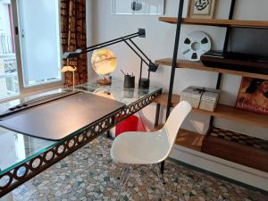 a glass desk with a chair and a lamp at Stipologic 6P 2BR in Paris +51 photos