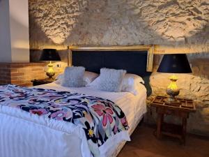 a bedroom with a bed and two lamps on tables at LaChiusa Tuscany in Montefollonico