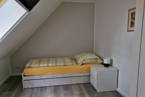 a bedroom with a bed and a white cabinet at Beekenhof in Bommelsen
