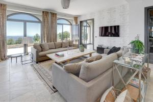 a living room with a couch and a table at Maison Saint Christophe in Grasse