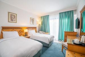 Ένα ή περισσότερα κρεβάτια σε δωμάτιο στο Azal Pyramids Hotel