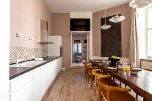 a kitchen with a long wooden table and chairs at Deluxe Apartment at Perfect Location in Copenhagen