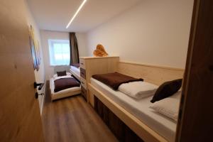 a bedroom with two bunk beds and a window at Gasserhof in Campo di Trens