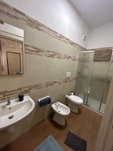 a bathroom with a sink and a toilet and a shower at Park and House Sopramarzo in Bari +5 photos