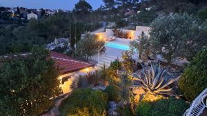 an aerial view of a house with a swimming pool at night at Apartmani Stipe in Drage
