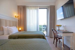 Postel nebo postele na pokoji v ubytování Iris Hotel