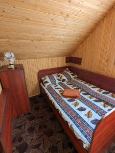 Bett in einem Zimmer mit Holzdecke in der Unterkunft Villa ALVIK in Geoagiu-Băi