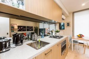 a kitchen with a sink and a counter top at Air Conditioned One Bedroom with Pool Close To CBD in Sydney