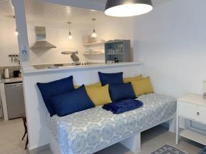 a bench with blue and yellow pillows in a kitchen at The Guest House in Skiathos