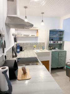 a kitchen with a counter and a stove top oven at The Guest House in Skiathos
