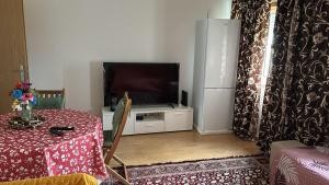 a living room with a table and a flat screen tv at Ranjeet felizarda in Lisbon