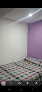 Tempat tidur dalam kamar di Comfort Home Escalón