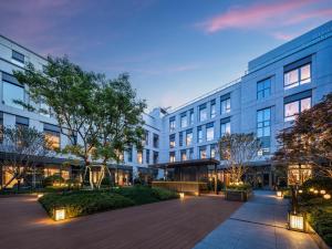 an exterior view of a building with a courtyard at Holiday Inn Express Beijing Zhongguancun Tech Park, an IHG Hotel in Beijing