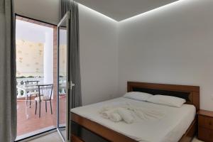 a bedroom with a bed and a sliding glass door at Vila Melisa in Ksamil +68 photos