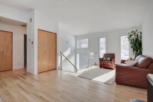 a living room with a couch and a chair at Cozy home with hot tub near airport in Quebec City