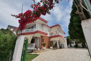 a house with flowers on the front of it at Vila Melisa in Ksamil