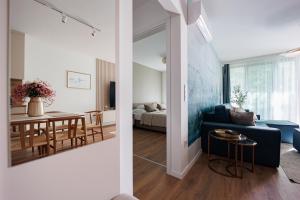 a living room with a couch and a table at Wave Luxury Apartment in Siófok