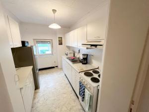 a kitchen with white cabinets and a stove top oven at 5 Room Apartment in Zülpich in Zülpich