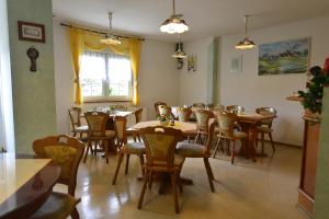 a dining room with wooden tables and chairs at Christel's Pension in Brandenburg an der Havel