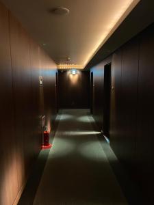 a hallway with a dark corridor with a dark hallway at Hotel BIX Tokyo Gotanda in Tokyo