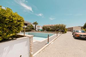 a car parked next to a swimming pool at Delmare Delia maisonette in Yerakiní