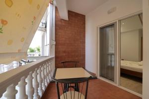 a balcony with a table and two chairs and a bedroom at Vila Melisa in Ksamil