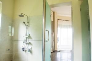 金贾Nile Retreat - Luxury Villa in Jinja的浴室里有玻璃门的淋浴间