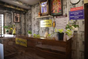 a restaurant with a counter with potted plants on it at virat inn in Bangalore