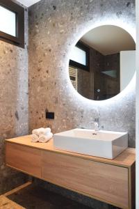 a bathroom with a white sink and a mirror at La casa di Cesare in Rogno