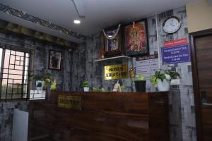 a counter in a restaurant with a clock on the wall at virat inn in Bangalore