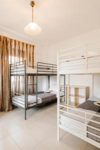 a bedroom with two bunk beds in a room at Delmare Delia maisonette in Yerakiní +43 photos