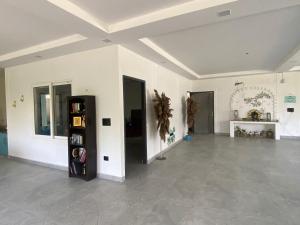 a large room with white walls and tile floors at X-Plosiv Farm in Noida