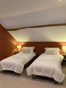 Postel nebo postele na pokoji v ubytování Chambres & Table d'hôtes de La Vieille Ferme