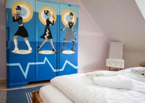 ヴィンターベルクにあるFerienhaus Grenzwegの三人の絵画が描かれた壁のベッドルーム