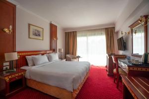 Ένα ή περισσότερα κρεβάτια σε δωμάτιο στο Azal Pyramids Hotel