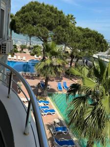 a view of a resort with chairs and a pool at Sunset Appartment in Golem