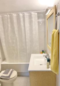 a bathroom with a sink and a toilet and a shower curtain at Villa Alexandros in Porto Heli +16 photos