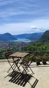 a picnic table and two chairs sitting on a balcony at La casa di Cesare in Rogno