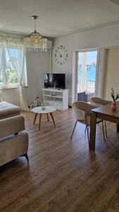 a living room with a couch and a table at Apartment Lučka in Rab