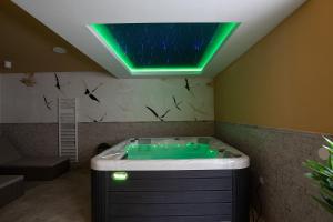 a bathroom with a tub with a green lighting at Villa Estrella in Medulin for 10 people with sauna & whirpool just 6 m from the sea in Medulin