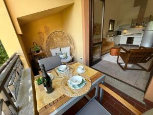 a room with a table with a laptop on a balcony at Sole e Lago in Stresa