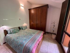a bedroom with a bed and a wooden cabinet at Sole e Lago in Stresa +13 photos