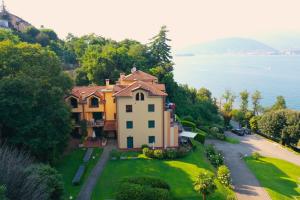 a large house on a hill next to the water at Sole e Lago in Stresa