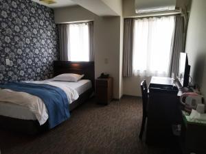 Postel nebo postele na pokoji v ubytování Business Hotel Azuma