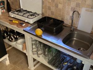 a kitchen counter top with a sink and a sink at Wild Glamping Portugal with hot tub to relax in Viana do Castelo in Viana do Castelo
