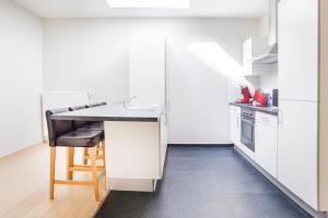 a kitchen with a counter and a table in it at Smartflats City - Brusselian in Brussels