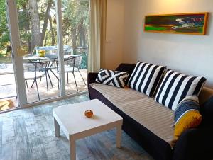 a living room with a couch and a table at MaraMare Apartments in Stara Baška