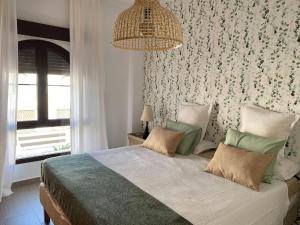 En eller flere senge i et værelse på Casa Playa la Jara