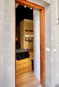 an open door to a room with a bed in it at La Nica in Palermo